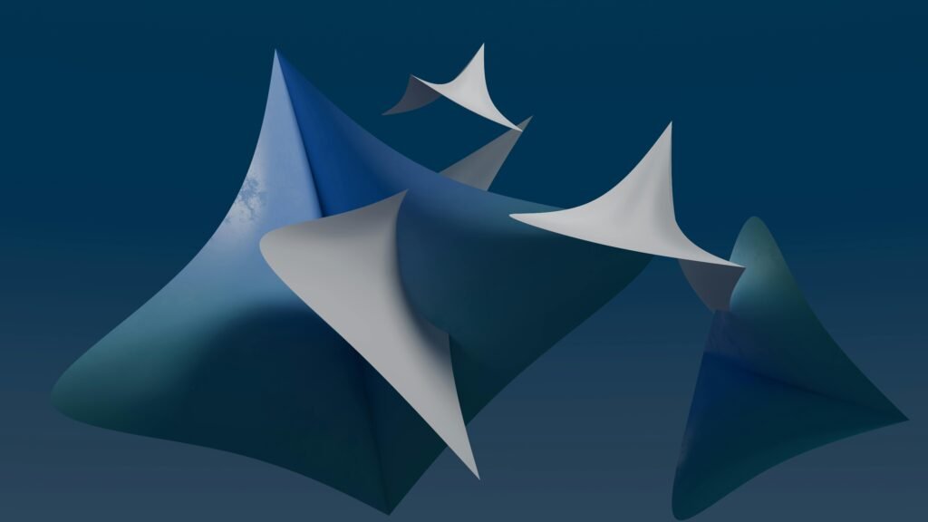 Dynamic 3D abstract shapes in a pleasing composition against a deep blue backdrop.