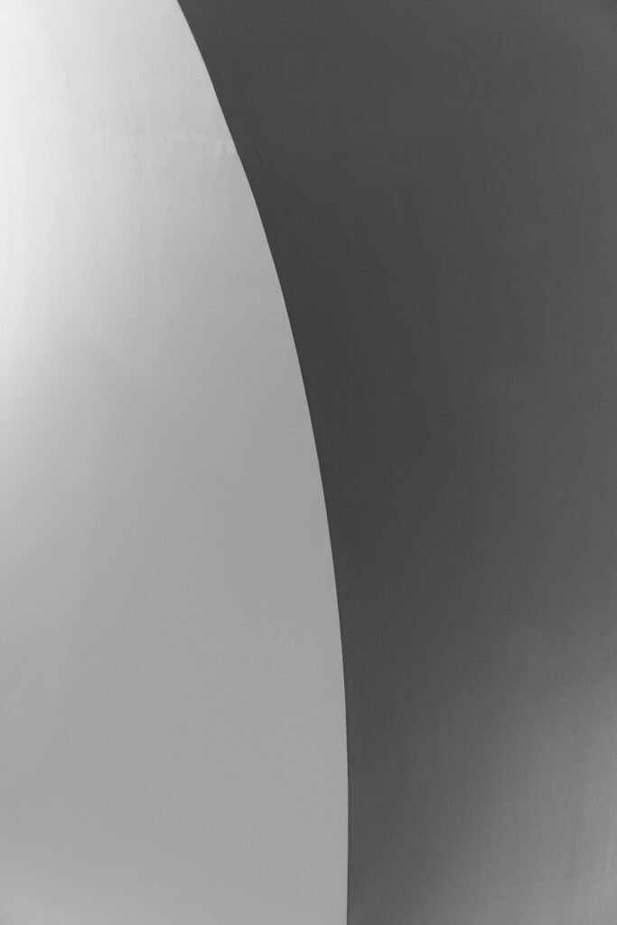 pexels photo 3694708 3694708 A high contrast black and white abstract image featuring smooth curved lines and minimalist design.